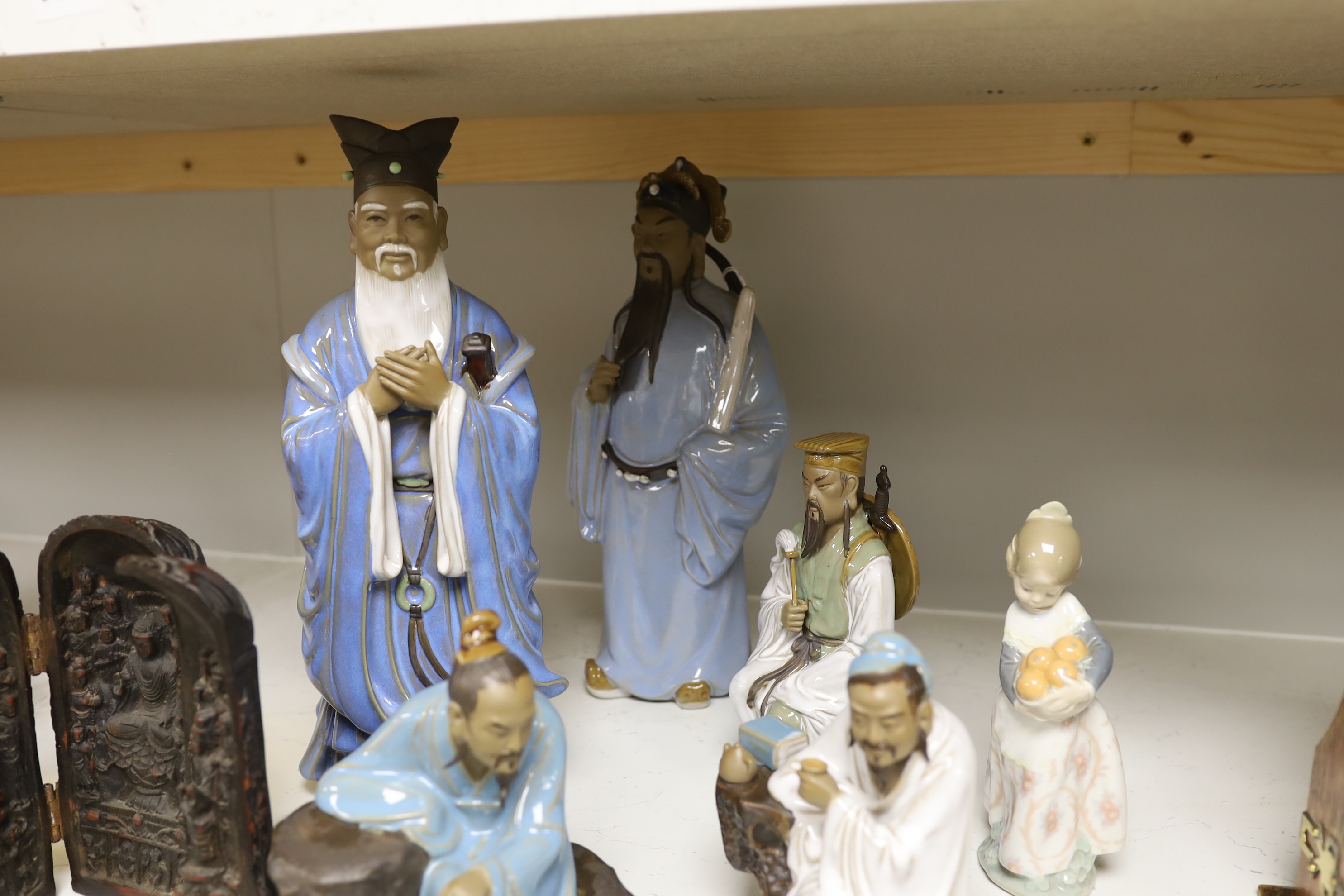 A group of Chinese Shiwan stoneware figures, a composition triptych shrine and a Lladro figure, tallest 33cm high